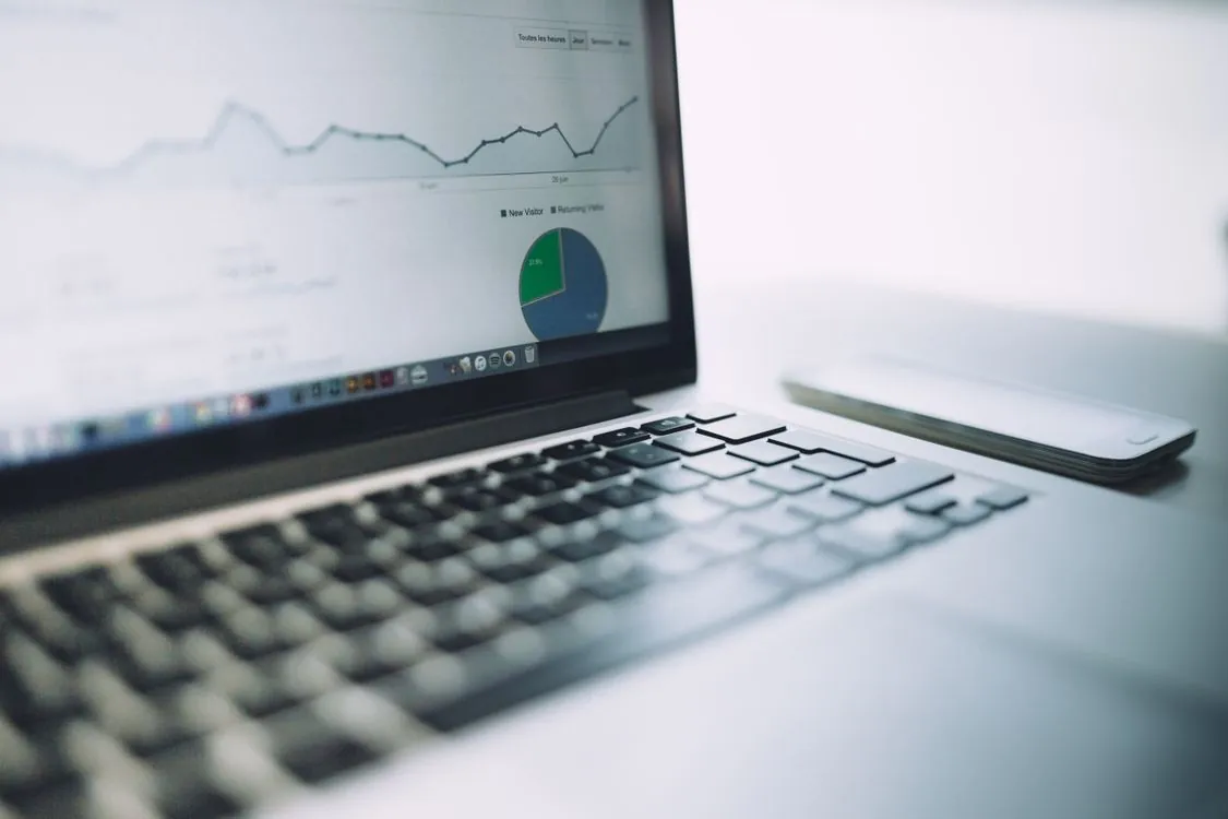 Laptop showing a business analytics dashboard with charts